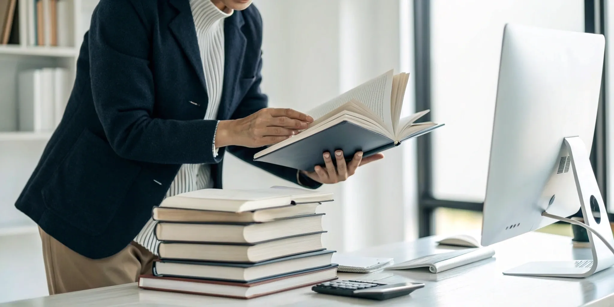 Reading Genius® 3.0 Blog 23 Person at a desk with books, learning from the best speed reading course for memory.